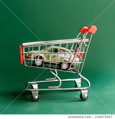 Toy car is sitting on a shopping cart. Toy car is sitting on a shopping cart. 130875407