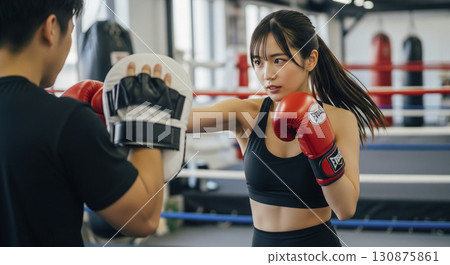 Woman hitting a mitt 130875861