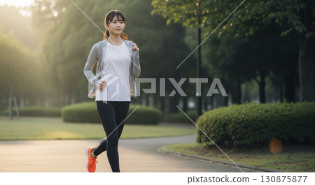 A woman running early in the morning 130875877