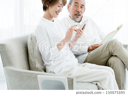 A senior couple using DX services A senior couple using DX services 130875895