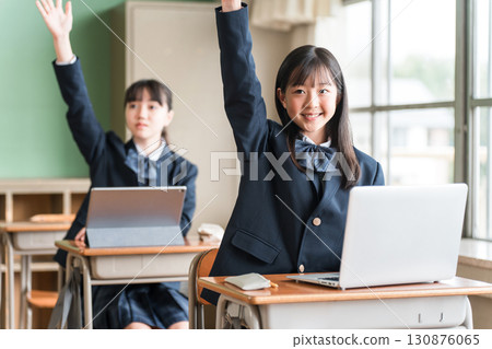 Junior high and high school girls in uniforms studying using a computer Junior high and high school girls in uniforms studying using a computer 130876065