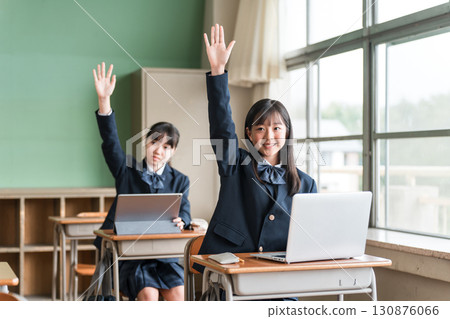 Junior high and high school girls in uniforms studying using a computer Junior high and high school girls in uniforms studying using a computer 130876066