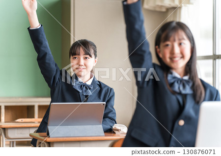 Junior high and high school girls in uniforms studying using a computer Junior high and high school girls in uniforms studying using a computer 130876071