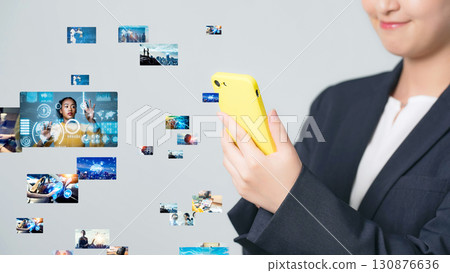 A woman watching video on a smartphone 130876636