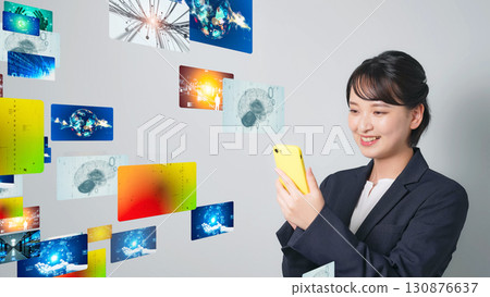 A woman watching video on a smartphone 130876637