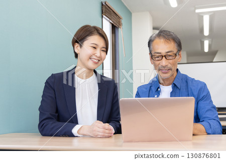 Seniors attending a computer class and a teacher Seniors attending a computer class and a teacher 130876801