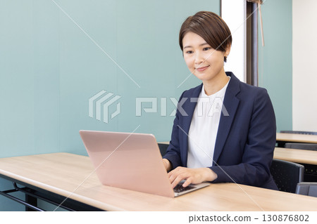 Business Portrait of a woman working on a personal computer Business Portrait of a woman working on a personal computer 130876802