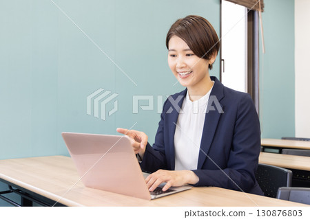 Business Portrait of a woman working on a personal computer Business Portrait of a woman working on a personal computer 130876803