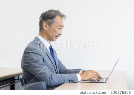 Senior businessman using a computer 130876806
