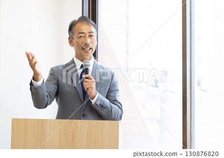 Senior businessman giving a presentation 130876820