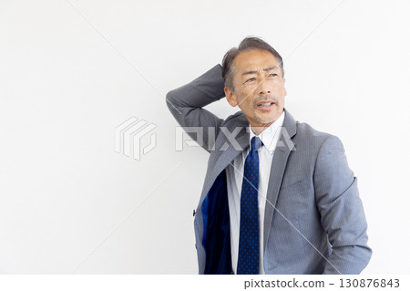 Forgetful middle-aged businessman Forgetful middle-aged businessman 130876843