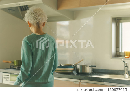 Elderly woman standing in the kitchen Elderly woman standing in the kitchen 130877015
