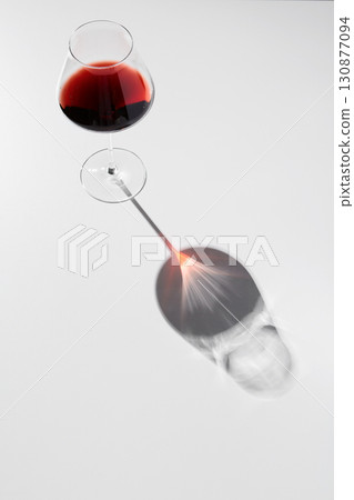 Black and red reflection of wineglass on thin stem. Black and red reflection of wineglass on thin stem. 130877094