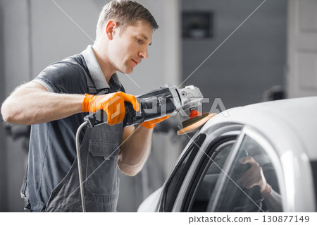 Car polishing in auto repair shop, close-up image. Car polishing in auto repair shop, close-up image. 130877149