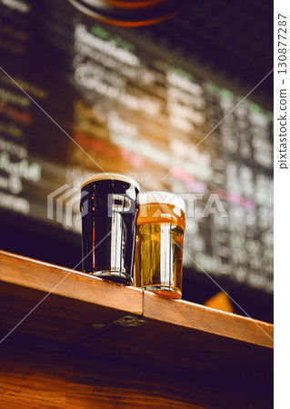 Two Beer Glasses with Craft Beer Selections on Bar Counter With Blurred Background Showcasing Drink Options Two Beer Glasses with Craft Beer Selections on Bar Counter With Blurred Background Showcasing Drink Options 130877287