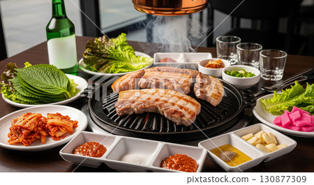 Korean BBQ Samgyeopsal Pork Belly with Side Dishes and Soju Korean BBQ Samgyeopsal Pork Belly with Side Dishes and Soju 130877309