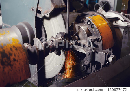 Grinding of the crankshaft on a grinding machine. Car tuning, engine power amplification. Grinding of the crankshaft on a grinding machine. Car tuning, engine power amplification. 130877472