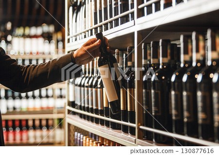 Cavist Selecting Fine Bottle From Extensive Wine Cellar Collection 130877616