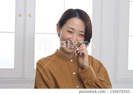 Woman on the phone (smiling) 130878203