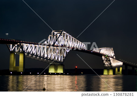 Tokyo Gate Bridge (Tokyo) rising into the night sky 130878281