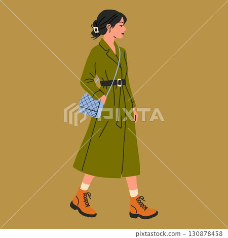 Woman in Green Coat and Boots Walking with Handbag 130878458