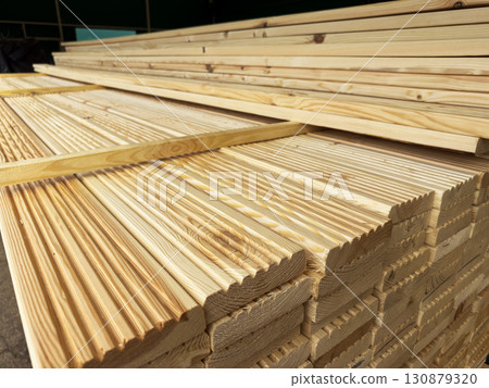 Wooden boards and slabs in the warehouse of the hardware store or in a construction hypermarket.  130879320