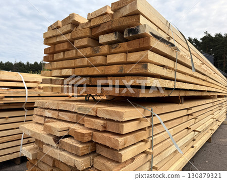 Wooden boards and slabs in the warehouse of the hardware store or in a construction hypermarket. Wooden boards and slabs in the warehouse of the hardware store or in a construction hypermarket. 130879321