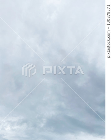Vertical background image 3 of a dark white-gray cloudy sky covered with rain clouds 130879371