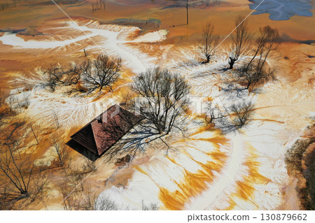 Aerial view of sinking village house in the middle of toxic mine decanting lake Aerial view of sinking village house in the middle of toxic mine decanting lake 130879662