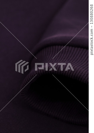 Texture of a hoodie. Close-up of the sleeve of a dark purple hoodie. Warm textile fabric, macro. Texture of a hoodie. Close-up of the sleeve of a dark purple hoodie. Warm textile fabric, macro. 130880268