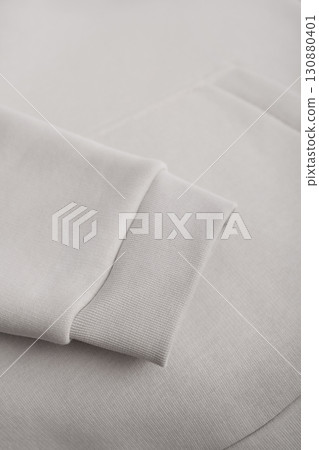 Hoodie texture. Close-up of the sleeve of a light gray hoodie. Cotton. Warm textile fabric, macro photography. 130880401