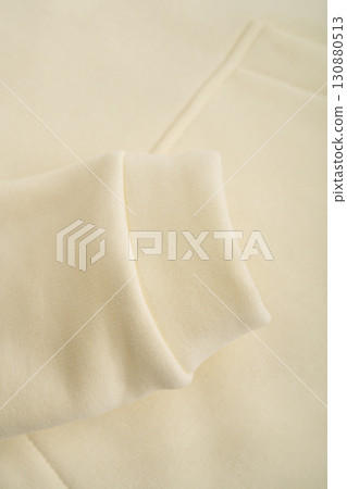 Hoodie texture. Close-up of the sleeve of a yellow hoodie. Cotton. Warm textile fabric, macro. Hoodie texture. Close-up of the sleeve of a yellow hoodie. Cotton. Warm textile fabric, macro. 130880513