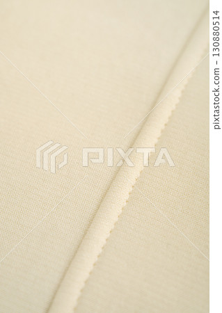 Yellow fabric with neat stitching. Cotton. Yellow fabric with neat stitching. Cotton. 130880514