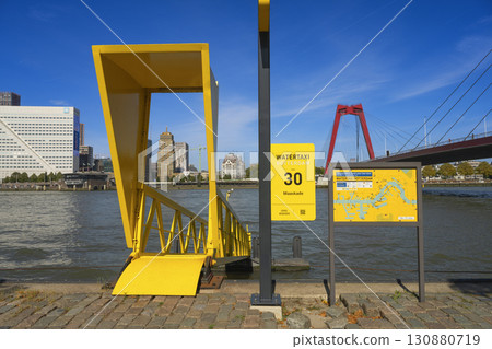 Rotterdam, the Netherlands. 06.09.2025, Water taxi in Rotterdam at the Maaskade pier with a view of the Willemsbrug bridge 130880719