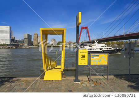 Rotterdam, the Netherlands. 06.09.2025, Water taxi in Rotterdam at the Maaskade pier with a view of the Willemsbrug bridge 130880721