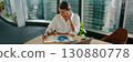 A Professional Woman Engaged in Active Work in a Contemporary Office Environment 130880778