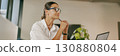 A Professional Woman Sitting in the Office Deep in Thought Within a Contemporary Workspace 130880804