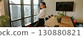 A professional woman is in her office making a crucial business call that may affect her career 130880821