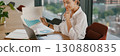 A confident businesswoman is analyzing growth data meticulously in a modern office space 130880835