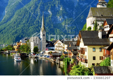 A stunning view of the beautiful village of Hallstatt, a World Heritage Site in Austria, reflected on Lake 130881207