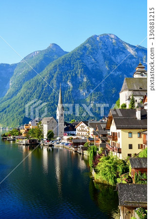 A stunning view of the beautiful village of Hallstatt, a World Heritage Site in Austria, reflected on Lake 130881215