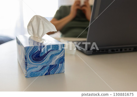 Sick Employee Working From Home Wipes Nose Near Computer 130881675