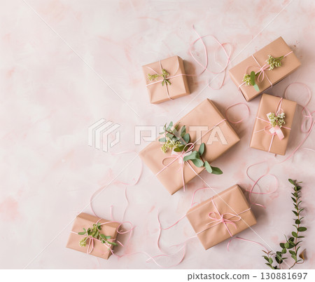 Elegant gift boxes arranged artistically with floral accents on a soft pastel background 130881697