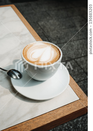 macchiato with heart shaped foam on a terrace table macchiato with heart shaped foam on a terrace table 130883203