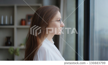 Close-up portrait of young beautiful business woman with brunette hair. Self-confident lady, good looking female executive with glasses on office background. Concept of a new idea Side view Copy Space 130883799