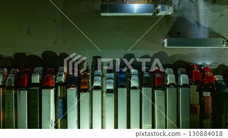 a row of vehicles, possibly buses or trucks, parked closely together  130884018