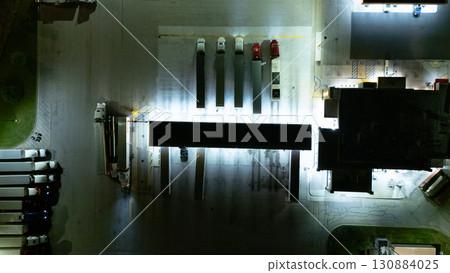 an area, possibly a parking lot or a section of a building complex, at night 130884025