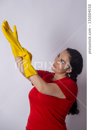 Woman in red shirt and yellow gloves Woman in red shirt and yellow gloves 130884038