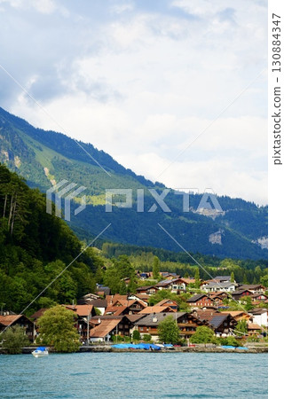 Lake Brienz and the town on its shores. Beautiful Swiss scenery surrounded by water and the Alps. Lake Brienz and the town on its shores. Beautiful Swiss scenery surrounded by water and the Alps. 130884347