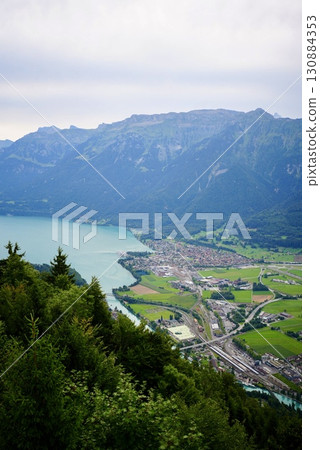 A spectacular view of Lake Brienz and the Alps from the summit of Harderkulm. A travel scene from Switzerland. 130884353